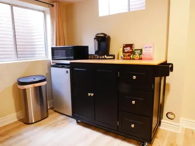 a kitchen with a counter with a microwave and a refrigerator at Private Basement, Bath, Living Area In Morrison in Morrison