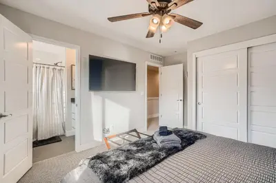 a bedroom with a ceiling fan and a bed at Stylish & Spacious Centrally-Located Home w/Garage in Wheat Ridge