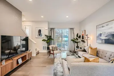 a living room with a couch and a tv at Stylish & Spacious Centrally-Located Home w/Garage in Wheat Ridge