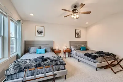 a bedroom with two beds and a ceiling fan at Stylish & Spacious Centrally-Located Home w/Garage in Wheat Ridge