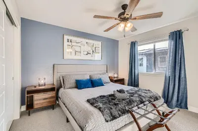 a bedroom with a bed and a ceiling fan at Stylish & Spacious Centrally-Located Home w/Garage in Wheat Ridge