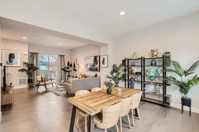 a dining room and living room with a table and chairs at Stylish & Spacious Centrally-Located Home w/Garage in Wheat Ridge