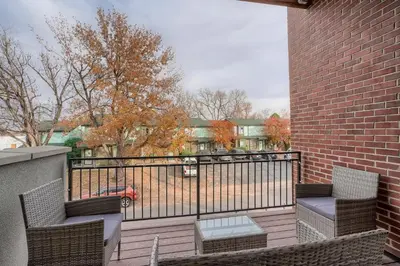 a balcony with two chairs and a fence at Stylish & Spacious Centrally-Located Home w/Garage in Wheat Ridge