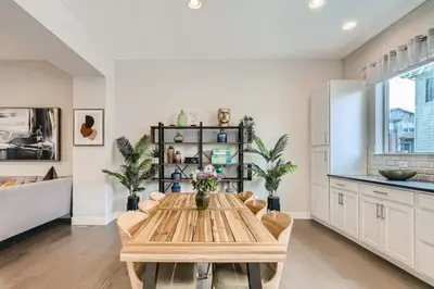 a dining room with a wooden table and chairs at Stylish & Spacious Centrally-Located Home w/Garage in Wheat Ridge