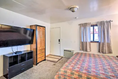 a bedroom with a bed and a flat screen tv at Loveland Vacation Rental - 1 Mile to Lake! in Loveland