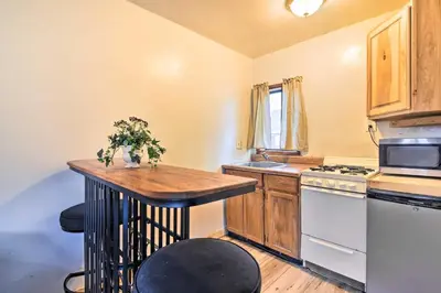 a kitchen with a table and a stove and a sink at Loveland Vacation Rental - 1 Mile to Lake! in Loveland