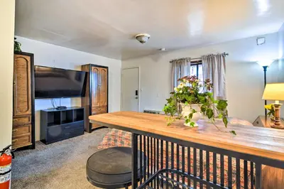 a living room with a table with flowers on it at Loveland Vacation Rental - 1 Mile to Lake! in Loveland