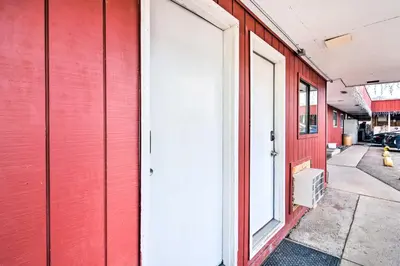 a red building with a white door and a sidewalk at Loveland Vacation Rental - 1 Mile to Lake! in Loveland