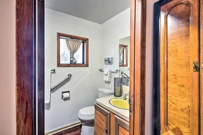 a bathroom with a white toilet and a sink at Loveland Vacation Rental - 1 Mile to Lake! in Loveland