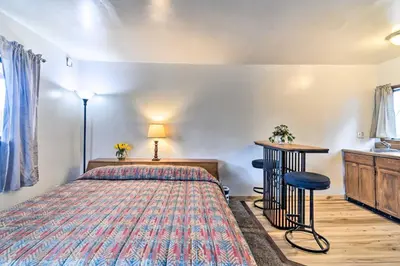 a bedroom with a bed and a table and a sink at Loveland Vacation Rental - 1 Mile to Lake! in Loveland