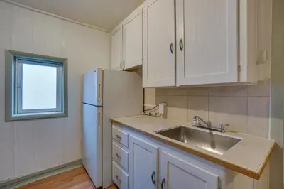 a kitchen with a sink and a white refrigerator at Pet-Friendly Loveland Studio Near Boyd Lake! in Loveland