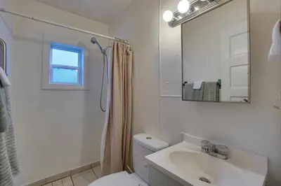 a bathroom with a toilet and a sink and a mirror at Pet-Friendly Loveland Studio Near Boyd Lake! in Loveland