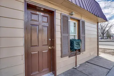 a door to a house with a green bag on it at Pet-Friendly Loveland Studio Near Boyd Lake! in Loveland