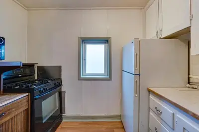 a kitchen with a white refrigerator and a window at Pet-Friendly Loveland Studio Near Boyd Lake! in Loveland