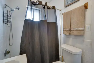 a bathroom with a shower curtain and a toilet at Pet-Friendly Vacation Rental Near Boyd Lake! in Loveland