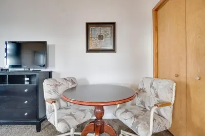 a room with a table and two chairs and a tv at Loveland Vacation Rental Near Downtown! in Loveland