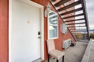 a white door and a chair on a porch at Loveland Vacation Rental Near Downtown! in Loveland