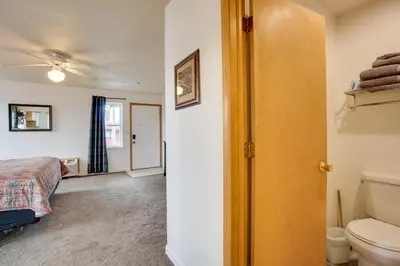 a bathroom with a bed and a toilet in a room at Loveland Vacation Rental Near Downtown! in Loveland