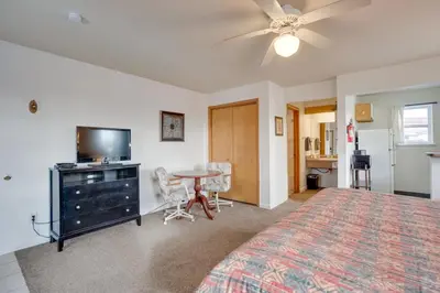 a bedroom with a bed and a table and a tv at Loveland Vacation Rental Near Downtown! in Loveland