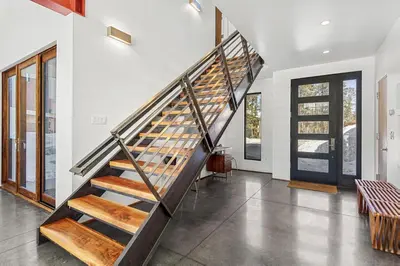 a staircase in a house with wooden steps at Modern Alpine Escape in Breckenridge