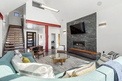 a living room with a blue couch and a fireplace at Modern Alpine Escape in Breckenridge