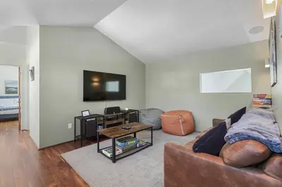 a living room with a couch and a tv at Modern Alpine Escape in Breckenridge