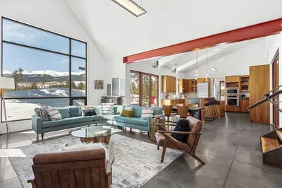 a living room with furniture and a large window at Modern Alpine Escape in Breckenridge