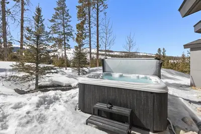 a jacuzzi tub in a yard in the snow at Modern Alpine Escape in Breckenridge
