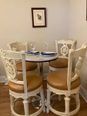 a table and chairs with wine glasses on it at Pineapple House, Spacious 1st Floor Apartment! City Center! 96 Walk Score! FREE parking! in Denver