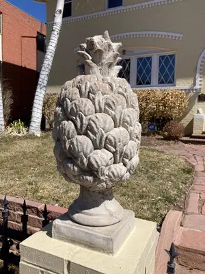 a statue of a pineapple in front of a house at Pineapple House, Spacious 1st Floor Apartment! City Center! 96 Walk Score! FREE parking! in Denver
