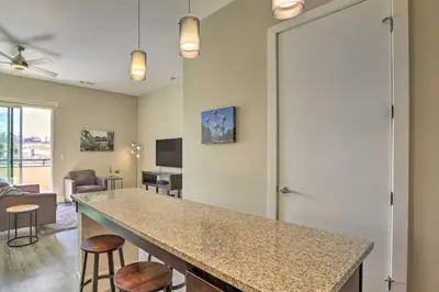 a kitchen and living room with a counter and stools at Near Coors Brewery and School of Mines Golden Unit in Golden