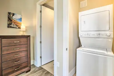 a laundry room with a washer and dryer next to a closet at Near Coors Brewery and School of Mines Golden Unit in Golden