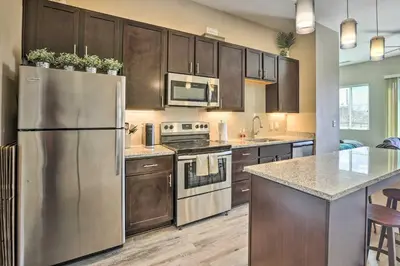 a kitchen with wooden cabinets and a stainless steel refrigerator at Near Coors Brewery and School of Mines Golden Unit in Golden