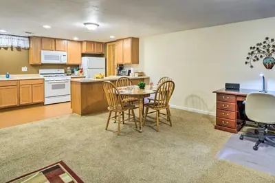 a kitchen and dining room with a table and chairs at Shared Patio and Fire Pit Denver Apartment in Denver