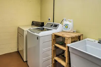 a laundry room with a washing machine and a sink at Shared Patio and Fire Pit Denver Apartment in Denver