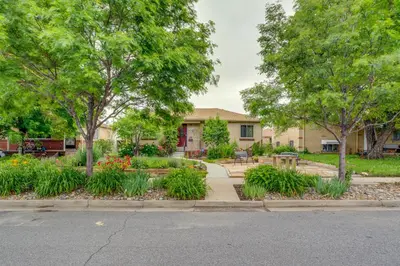a house with a garden with flowers and trees at Shared Patio and Fire Pit Denver Apartment in Denver