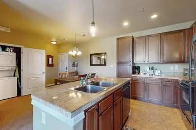 a large kitchen with wooden cabinets and a sink at The Great Granby Getaway in Granby