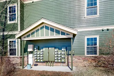 a green house with a garage with at The Great Granby Getaway in Granby