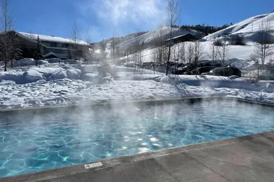 a hot tub in the snow with snow covered ground at The Great Granby Getaway in Granby