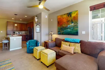 a living room with a couch and a kitchen at The Great Granby Getaway in Granby