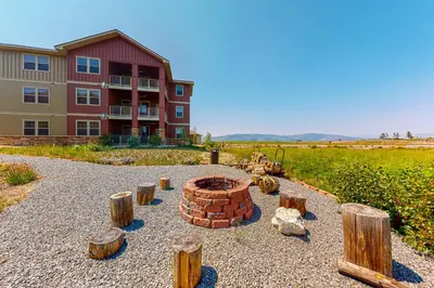 a brick fire pit in front of a building at The Great Granby Getaway in Granby