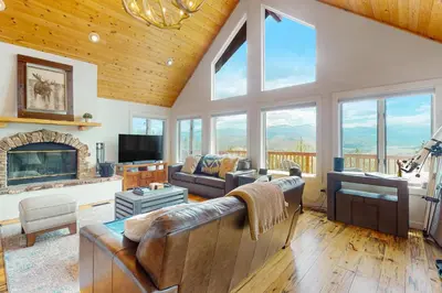 a living room with a couch and a fireplace at Rainbow Connection in Tabernash