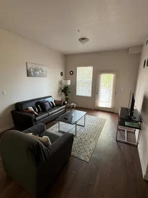 a living room with a couch and a table at Private 2Bdrm Apartment Convenient to All in Greeley
