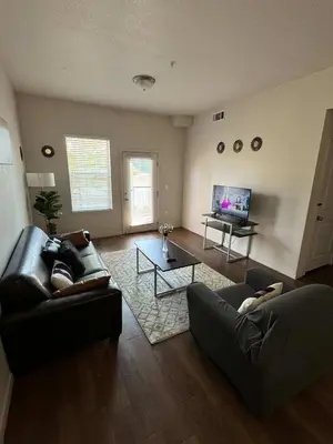 a living room with a couch and a table at Private 2Bdrm Apartment Convenient to All in Greeley