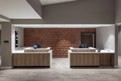 a lobby with two reception desks and a red wall at Residence Inn by Marriott Denver Aurora in Aurora
