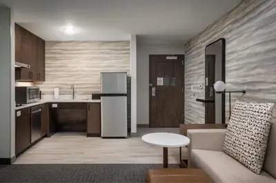 a kitchen and living room with a refrigerator and a couch at Residence Inn by Marriott Denver Aurora in Aurora
