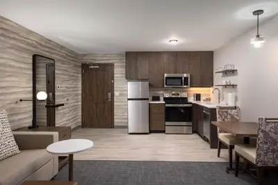 a kitchen and living room with a couch and a table at Residence Inn by Marriott Denver Aurora in Aurora