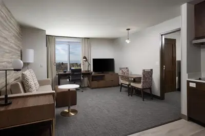 a room with a living room with a desk and a living room at Residence Inn by Marriott Denver Aurora in Aurora