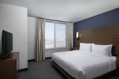 a hotel room with a bed and a large window at Residence Inn by Marriott Denver Aurora in Aurora