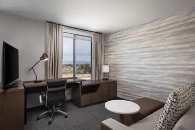 a hotel room with a desk and a computer in a room at Residence Inn by Marriott Denver Aurora in Aurora